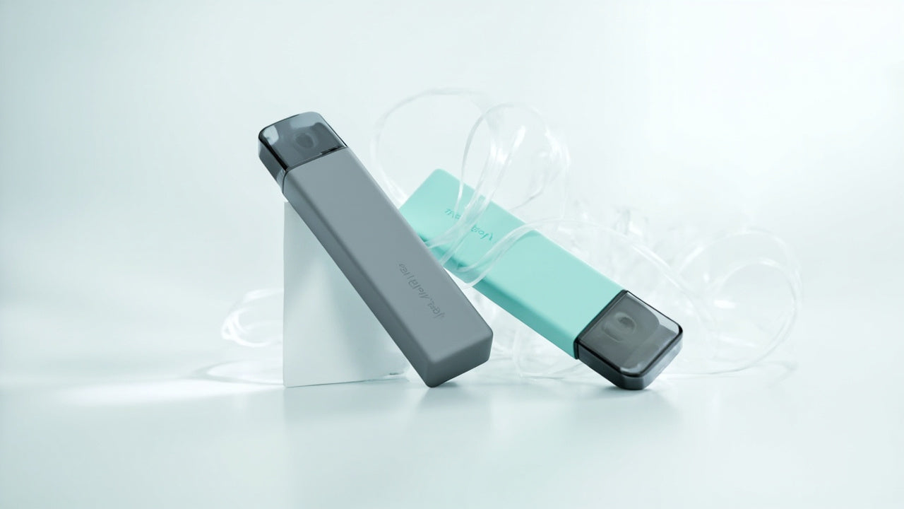 Two sleek disposable vape devices, one grey and one teal, on a clean white background.
